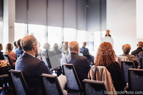 Image of Woman giving presentation on business conference event.