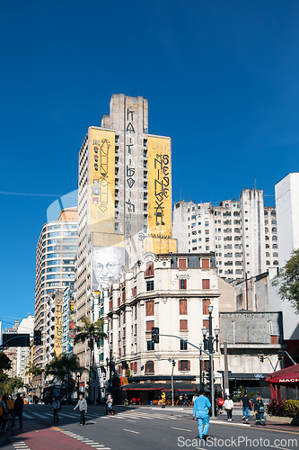 Image of Street view of downtown Sao Paulo, with people on a crosswalk and traffic on the road. Brazil