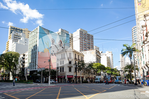 Image of Street view of downtown Sao Paulo, with people on a crosswalk and traffic on the road. Brazil