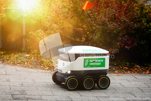 Image of Starship Autonomous Food Delivery Robot Driving on Pavement