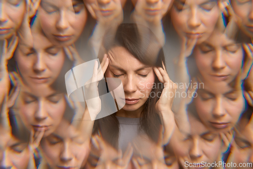 Image of Woman experiencing migraine with eyes closed and hands on temples,
