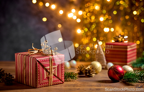 Image of beautiful Christmas Greeting card with wrapped gift box and blur