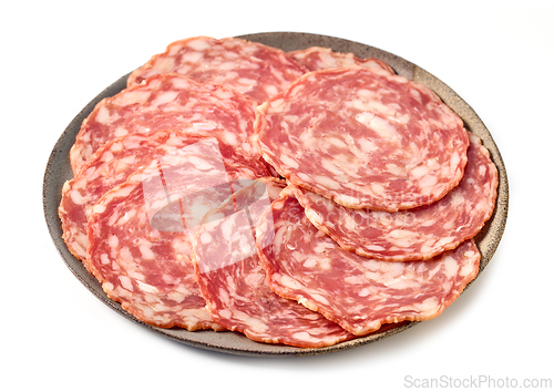 Image of plate of sliced dry spanish sausages isolated on white backgroun
