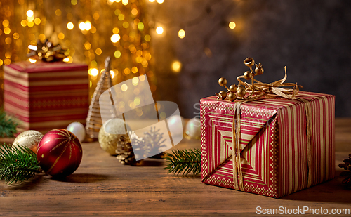 Image of beautiful Christmas Greeting card with wrapped gift box and blur