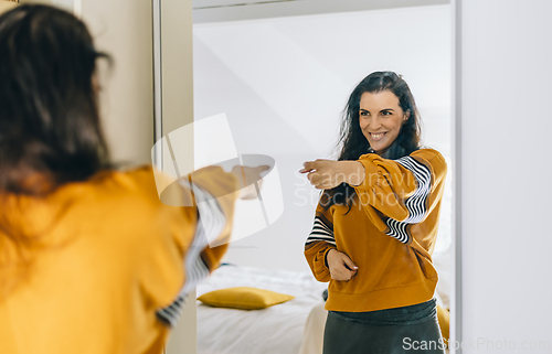 Image of Self confident single woman pointing finger at reflection in mir