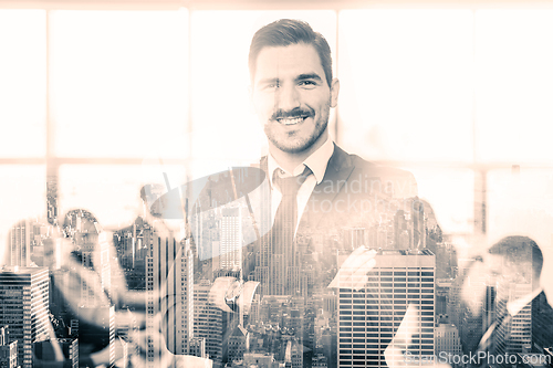 Image of Team leader with coworkers working in office.