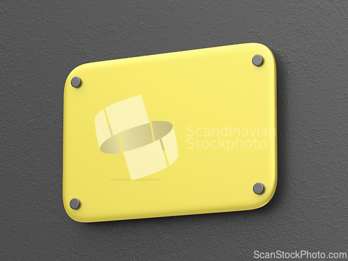 Image of Yellow nameplate on dark grey wall