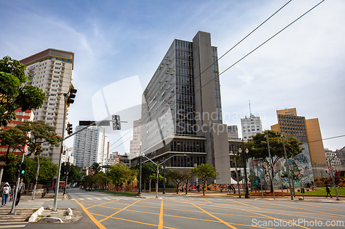 Image of Wide-angle view of a bustling urban street with modern buildings, a crosswalk, and street art in downtown Sao Paulo.