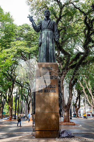 Image of Bronze statue of a religious figure holding a cross, a historic landmark in the vibrant public square Praca da Se in Sao Paulo.