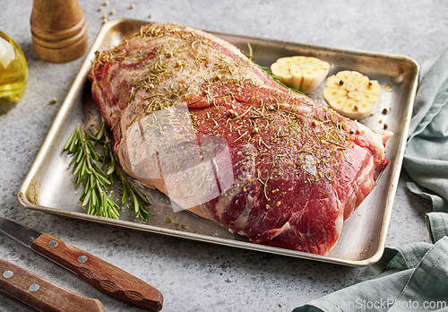 Image of fresh raw pork neck meat with garlic and spices