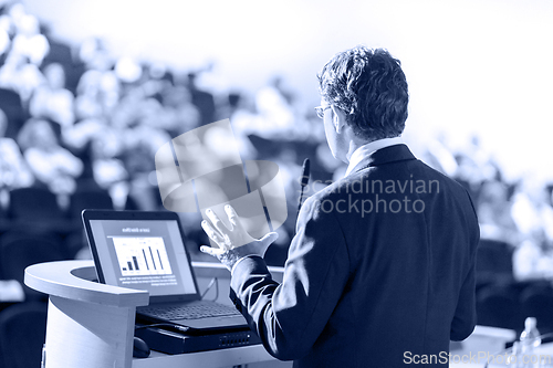 Image of Speaker Giving Presentation at Business Conference at Lecture Hall.