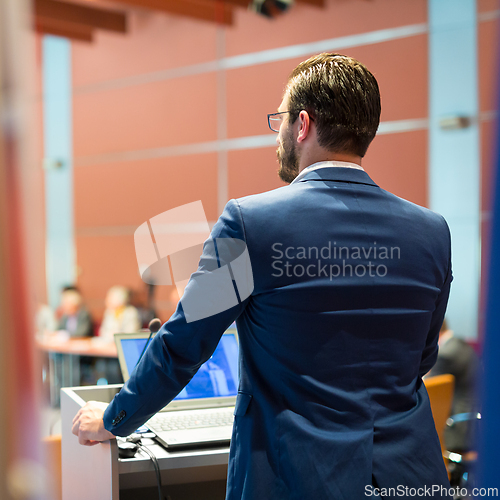 Image of Public speaker giving talk at Business Event.