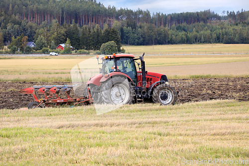 Image of Farmer Working in Field with Case IH Tractor and Plough