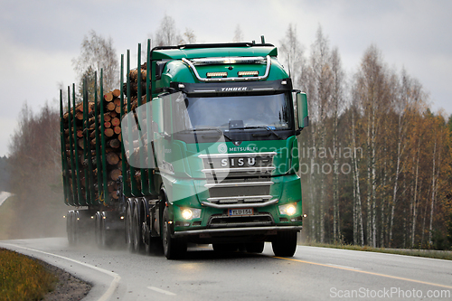 Image of Green Sisu Logging Truck Hauls Log Load in Autumn