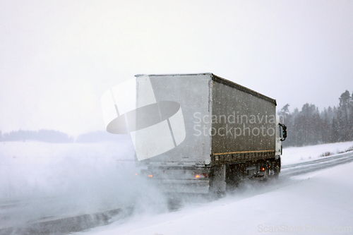 Image of Semi Truck Driving on Snowy Road