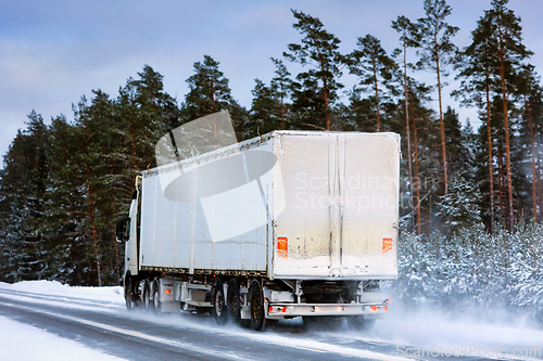 Image of Semi Truck Driving on Snowy Highway