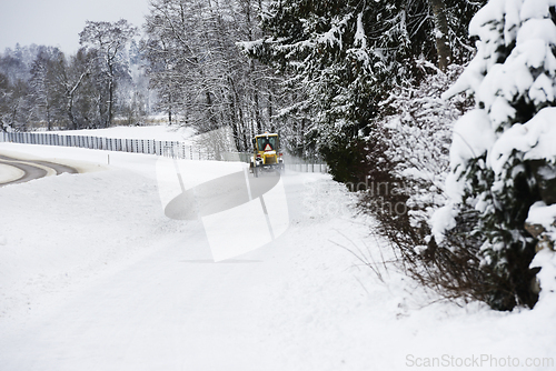 Image of A tractor driving through the snow