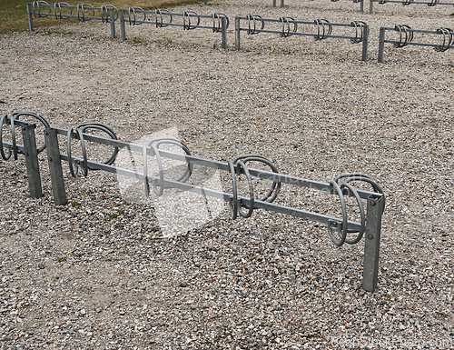 Image of bicycle parking on a dirt area