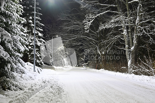 Image of snowy street of the small town of Pernio in Finland at night 