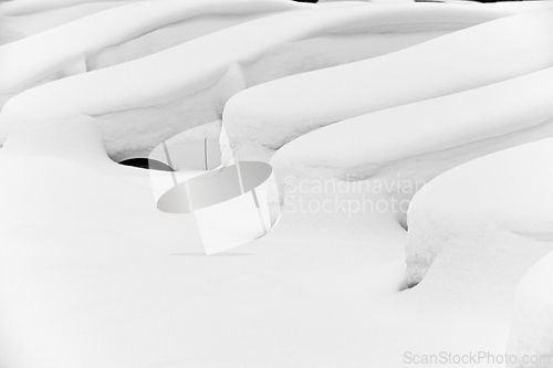 Image of cars covered with snow in the parking lot 