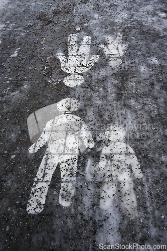 Image of  Ice covered sidewalk with a pedestrian path sign 