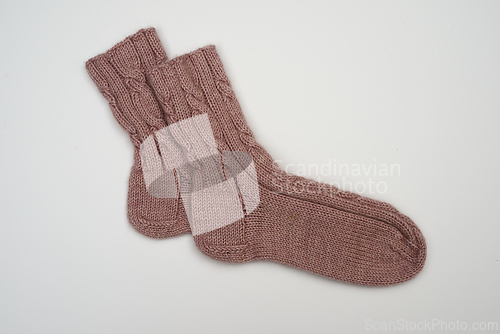 Image of knitted wool socks on a neutral background