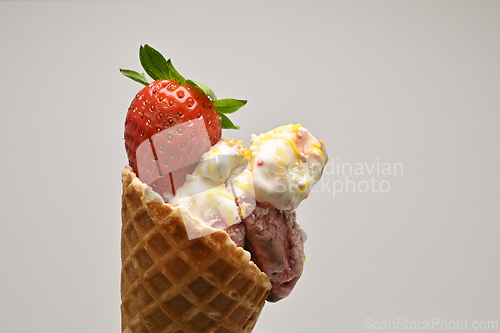 Image of Close-up shot of ice cream cone with strawberry