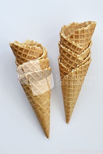 Image of Two empty waffle cones on white background