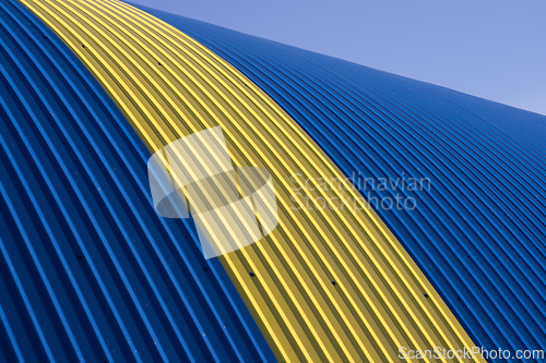 Image of Blue corrugated metal roof with rivets, exterior of a modern warehouse