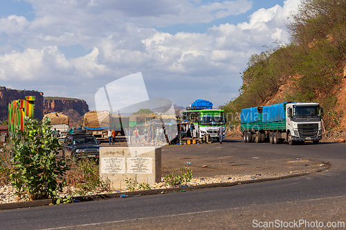 Image of Trucks and buses stop at a roadside rest area near the Blue Nile River Bridge in Ethiopia
