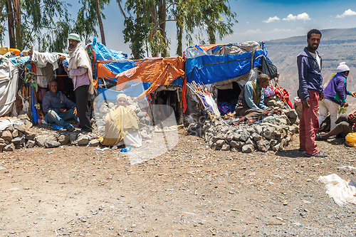 Image of People and their simple, makeshift housing structures built on the high-altitude terrain. Oromia region, Ethiopia