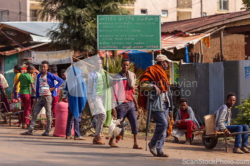 Image of Group of locals socializing and conducting small-scale trade on a dusty street. Demebecha, Ethiopia
