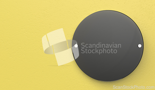 Image of Black blank signboard on yellow wall