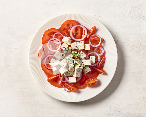 Image of plate of sliced tomato salad with fresh greek cheese