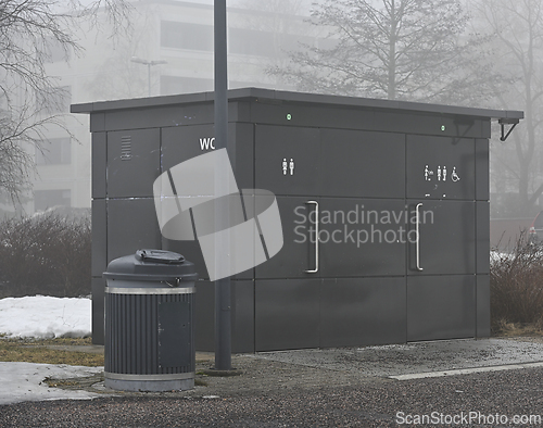 Image of public toilet and trash can in the park 