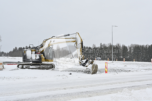 Image of Excavator operating in snowy conditions
