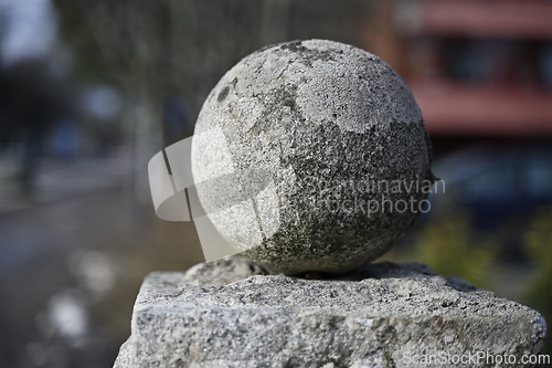 Image of old granite ball covered with moss