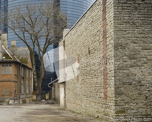 Image of old courtyard, tree and modern office building in Tallinn, Eston
