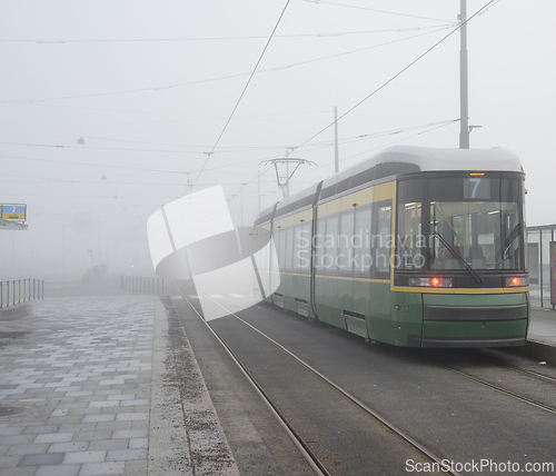 Image of city tram number 7 at a stop early in the morning in the fog i