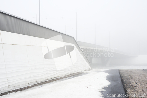 Image of concrete bridge in heavy fog in early spring 