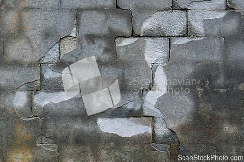 Image of Weathered wall reveals artful patterns in gray tones, inviting t