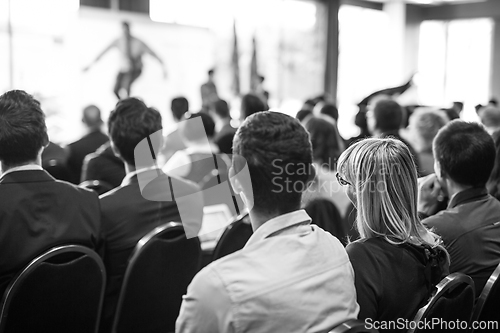 Image of Business speaker giving a talk at business conference event.