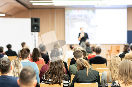 Image of Female speaker giving presentation on business conference.