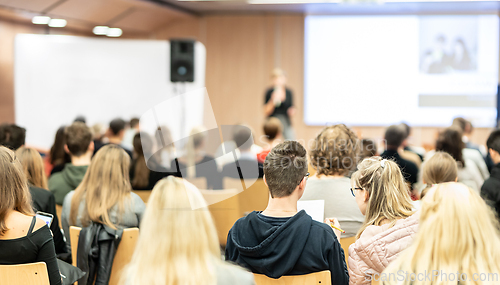 Image of Female speaker giving presentation on business conference.