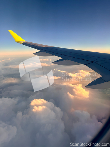 Image of Wing of an airplane flying above the clouds