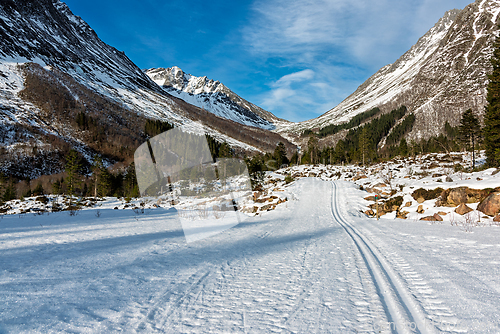 Image of Snow-covered valley paths invite exploration in a serene mountai