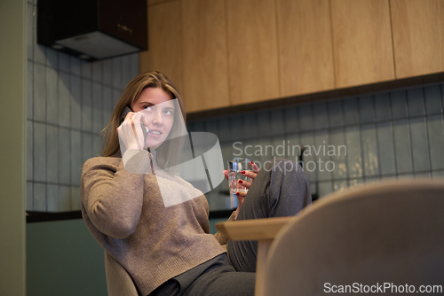 Image of Casual Conversation Over the Phone at the Kitchen Table