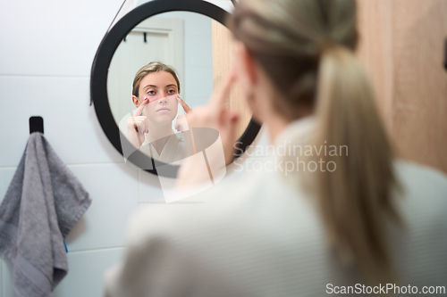 Image of Focused Skincare Moment in Front of the Mirror
