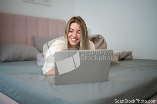 Image of Playful Morning Browsing While Resting in Bed