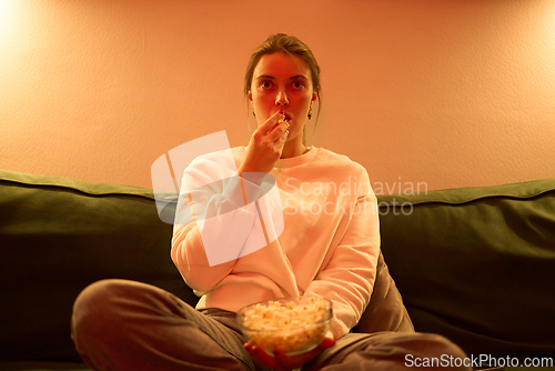Image of Evening Snack and Screen Time on a Cozy Sofa